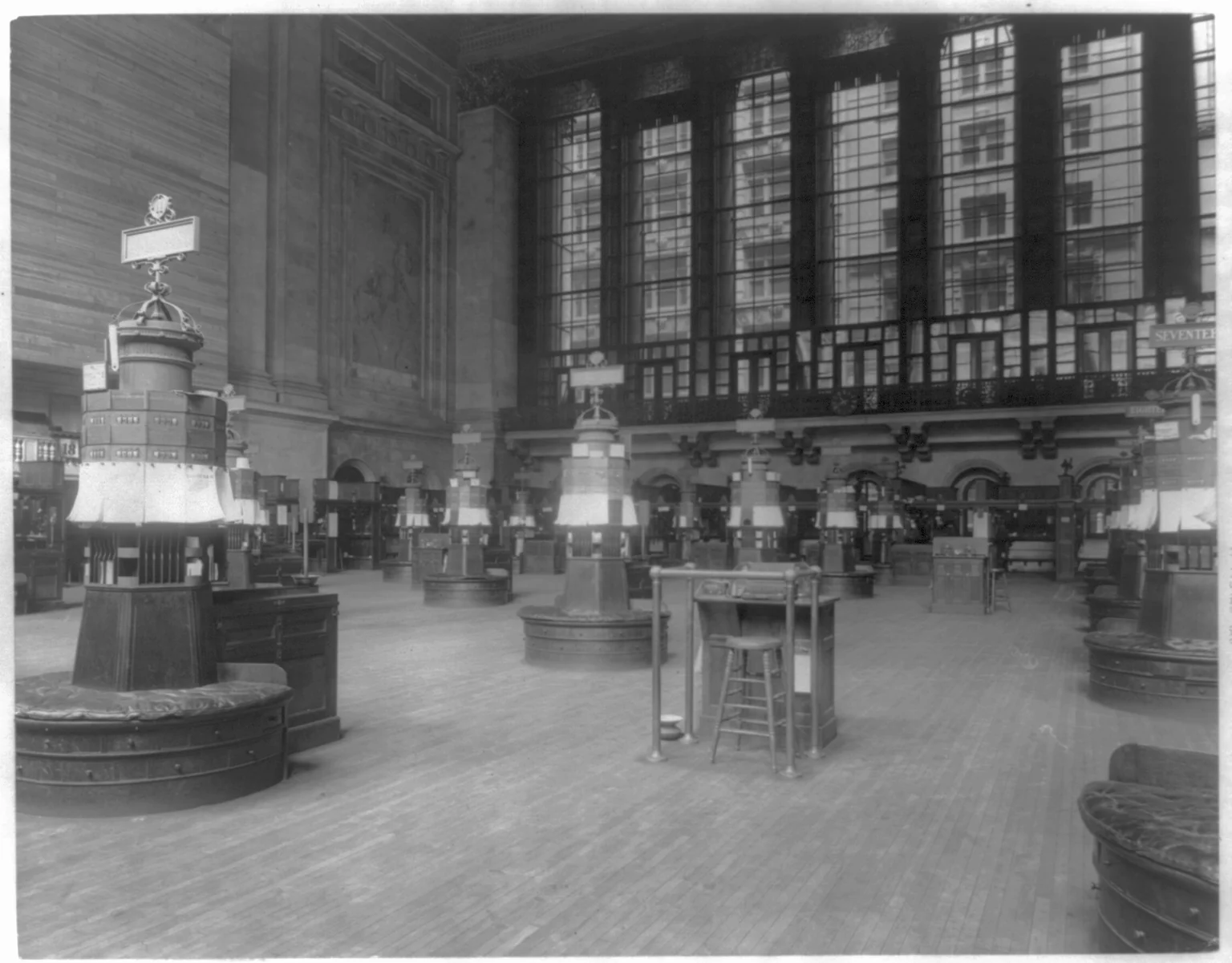 Black-and-white view of stock quotation stations and automatic ticker apparatus on the New York Stock Exchange floor in 1922.